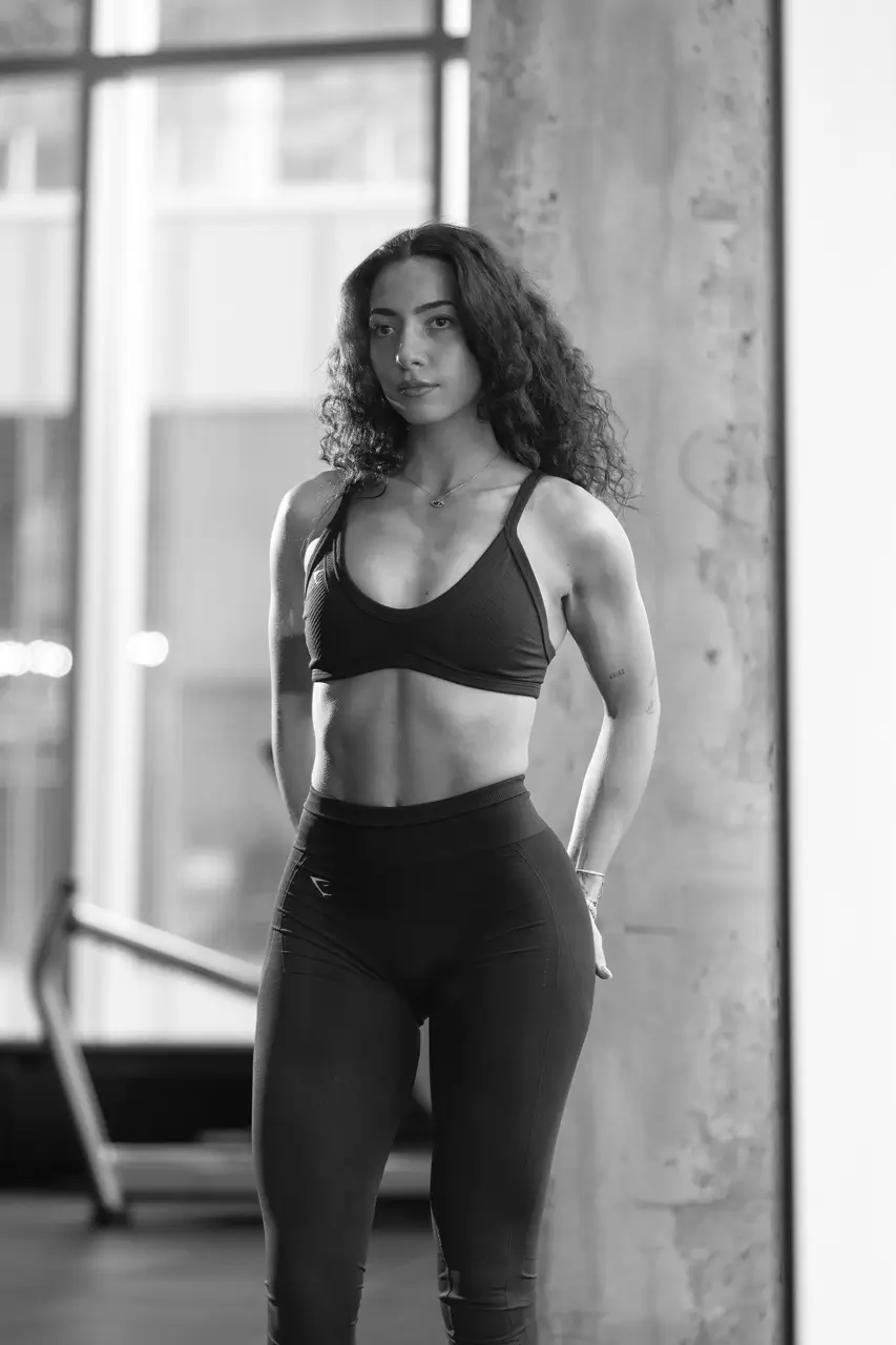 Gina Amin in workout apparel posing